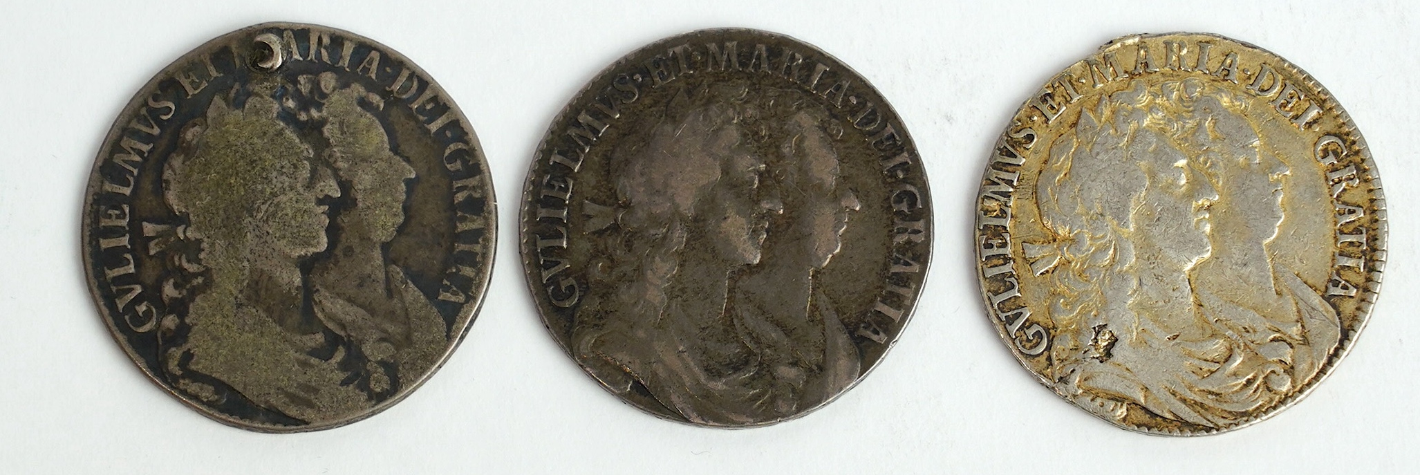 British silver coins, William and Mary (1689-94), three halfcrowns, all 1689, first reverse (S3434), the first fine, the second demounted and later gilded otherwise fine and the third holed, otherwise VG (3)